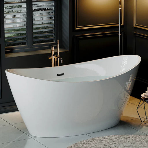 Modern white freestanding bathtub with gold fixtures, positioned near shuttered window in elegant dark bathroom with tiled floor.