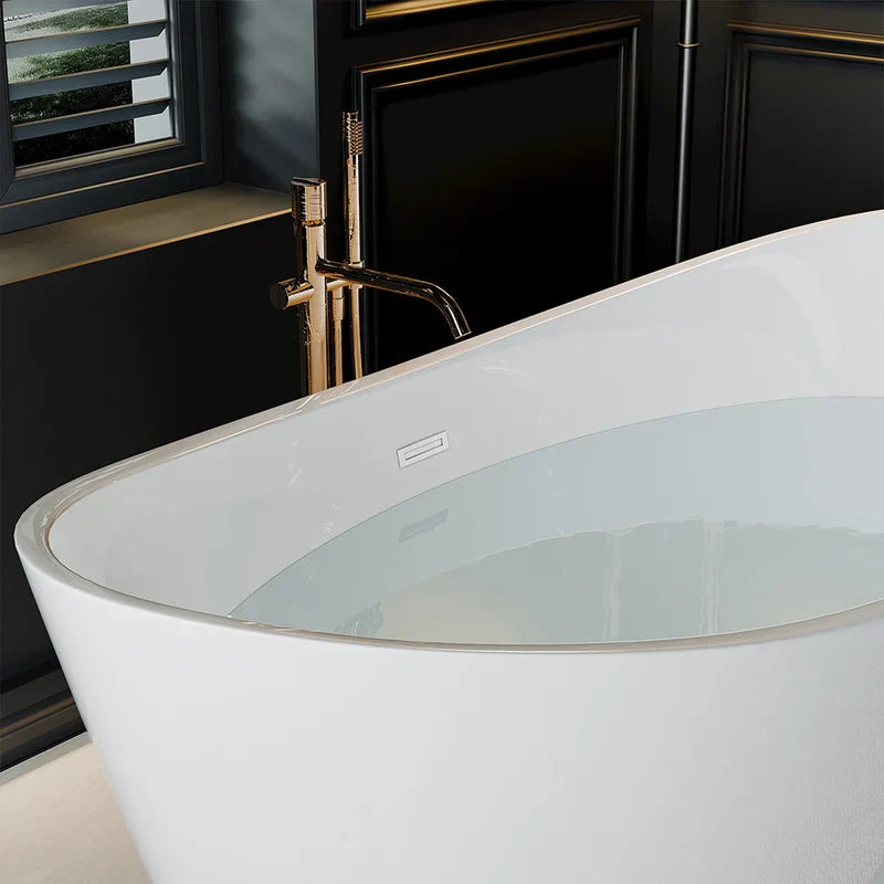Modern white freestanding bathtub with gold faucet in a dark, elegant bathroom with paneled walls and window.