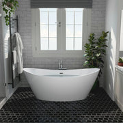 Modern bathroom with white freestanding tub, gray subway tiles, black hexagonal floor tiles, and green potted plants near a double window.