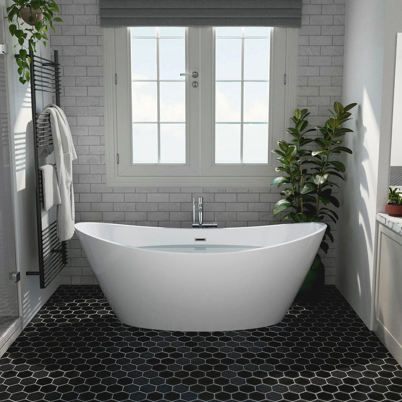 Modern bathroom with white freestanding tub, gray subway tiles, black hexagonal floor tiles, and green potted plants near a double window.
