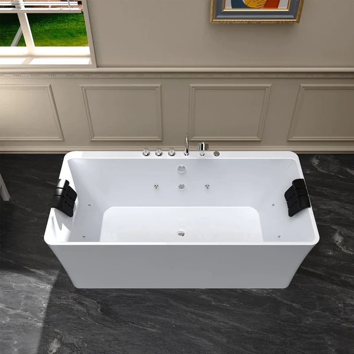 Modern white freestanding bathtub with chrome fixtures, positioned on dark marble floor with paneled wall and window in background