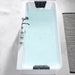 Modern white bathtub filled with light blue water, chrome faucet fixtures, and black comfort headrests at top and bottom.