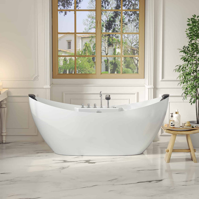 Modern white freestanding bathtub beneath large multi-paned window, with wooden side table and green plant, overlooking lush garden.