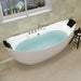 Modern white freestanding bathtub filled with light blue water, placed on tiled floor near window with blinds, featuring chrome fixtures and black cushioned headrests.
