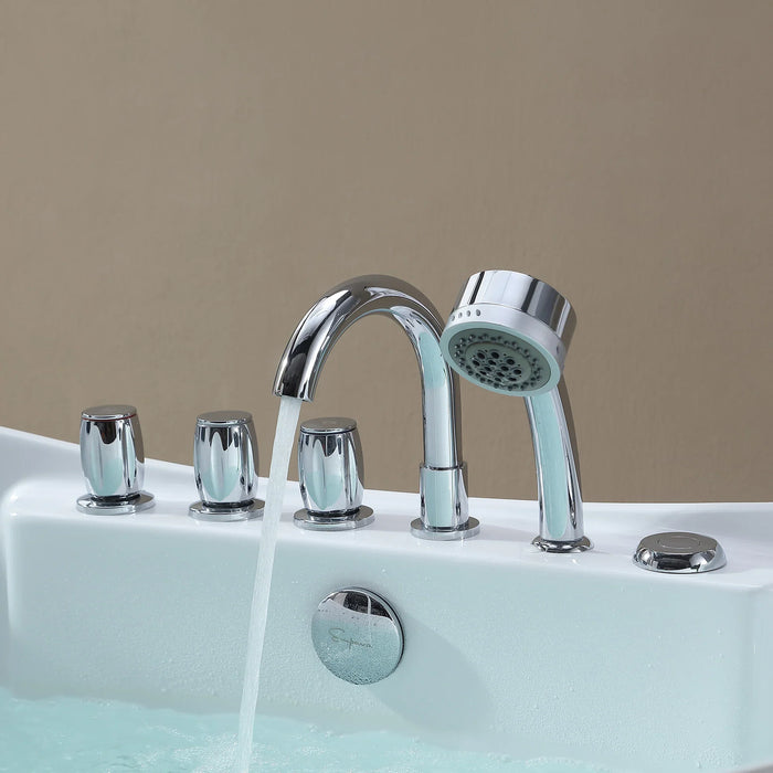 Chrome bathtub faucet with attached handheld showerhead, water running, mounted on a white tub with three additional control handles.