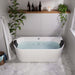 Modern bathroom with white freestanding tub, filled with water, surrounded by white subway tiles, hexagonal floor tiles, and green plants on a wooden shelf.