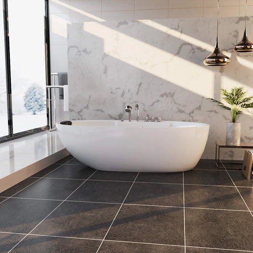 Modern bathroom with white freestanding bathtub, marble wall, dark tile floor, and pendant lights casting dramatic shadows.