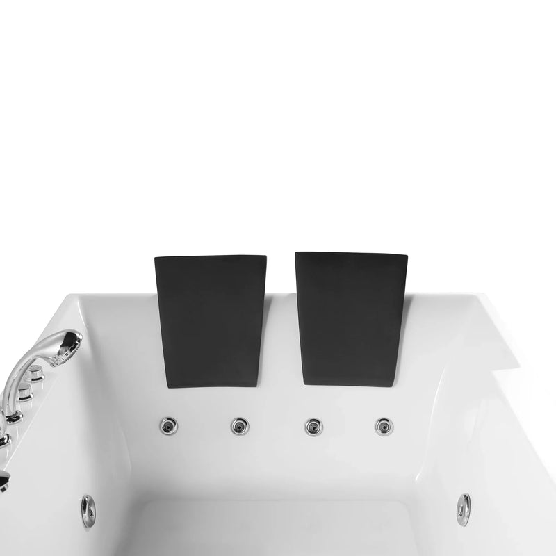 Two black rectangular headrests attached to a white whirlpool bathtub with chrome fixtures and multiple jets.