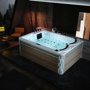 Modern hot tub with blue LED lighting, filled with water and multiple jets, situated in a dimly lit room with wood-paneled walls and forest view
