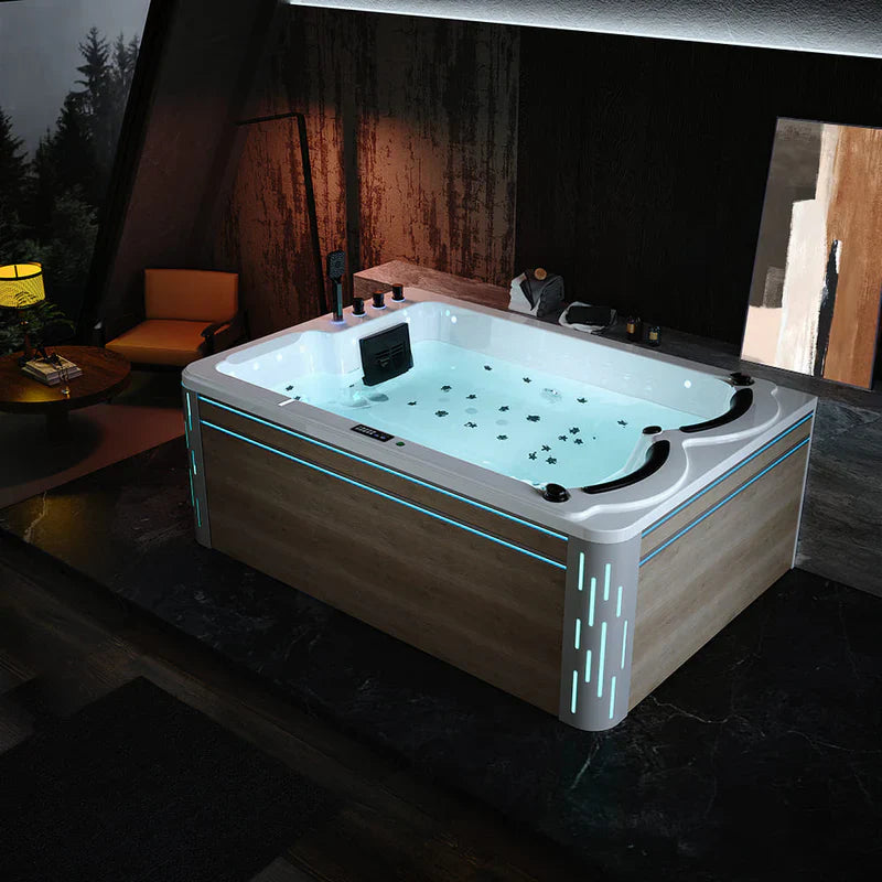 Modern hot tub with blue LED lighting, filled with water and multiple jets, situated in a dimly lit room with wood-paneled walls and forest view