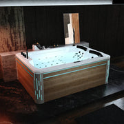 Modern hot tub with wood paneling and blue LED accent lighting, filled with bubbling water and multiple jets