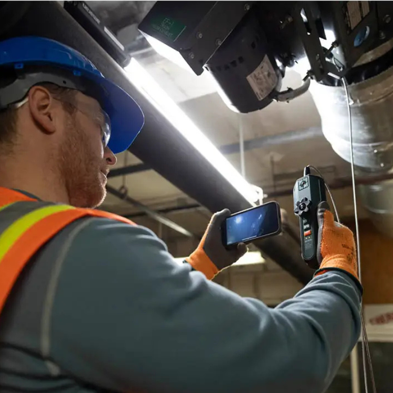 Extech Br450W A2 wireless borescope ceiling ductwork inspection worker using smartphone.