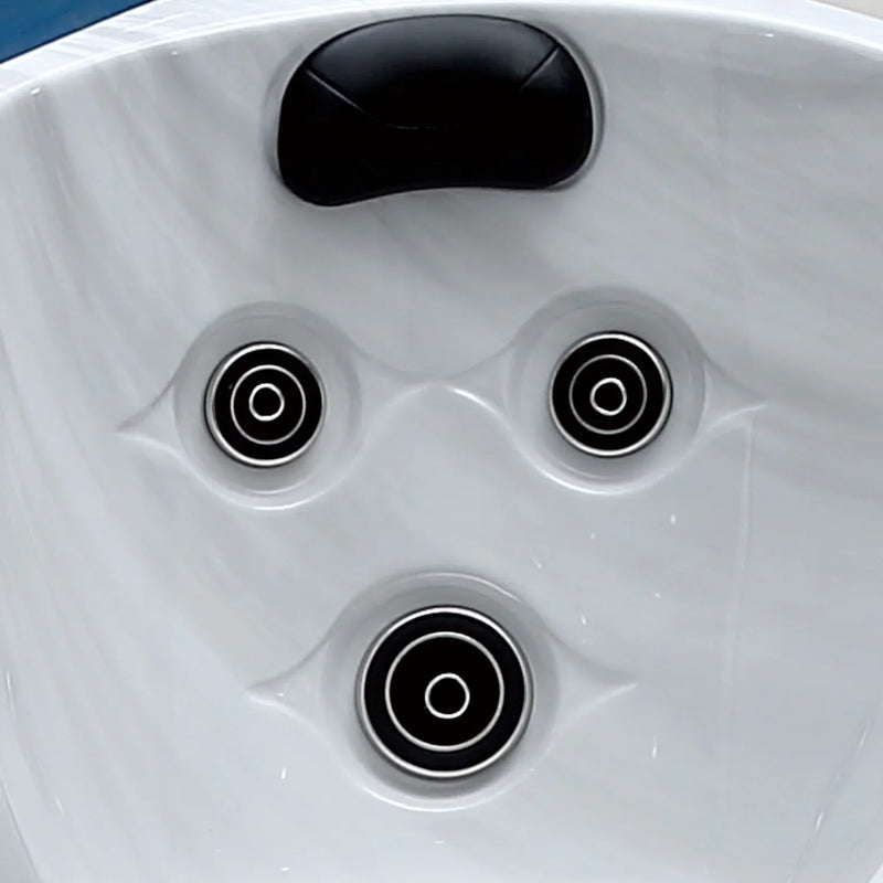 White hot tub surface with three black circular jets and a black headrest