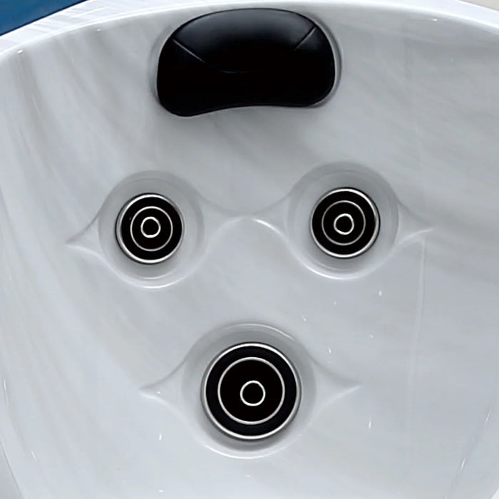 White hot tub surface with three black circular jets and a black headrest