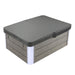 Rectangular hot tub with gray wood-paneled exterior and black hardtop cover, with white corner accents.