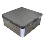 Hot tub with gray hard cover, wood-paneled exterior and white corner accents, closed and ready for use.