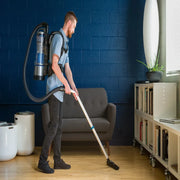 Prolux Lightweight 2.0 Bagless Upright Backpack Vacuum in use living room.