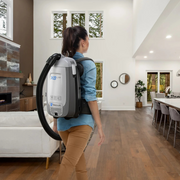 Prolux PLCX8E Backpack Vacuum Canister in use worn by woman in home.