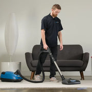 Prolux QX90 in use by person cleaning rug.