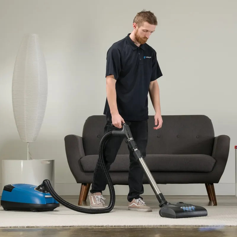Prolux QX90 in use by person cleaning rug.