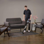 Prolux RS7 PET Cordless Handheld Stick Vacuum man using in living room.