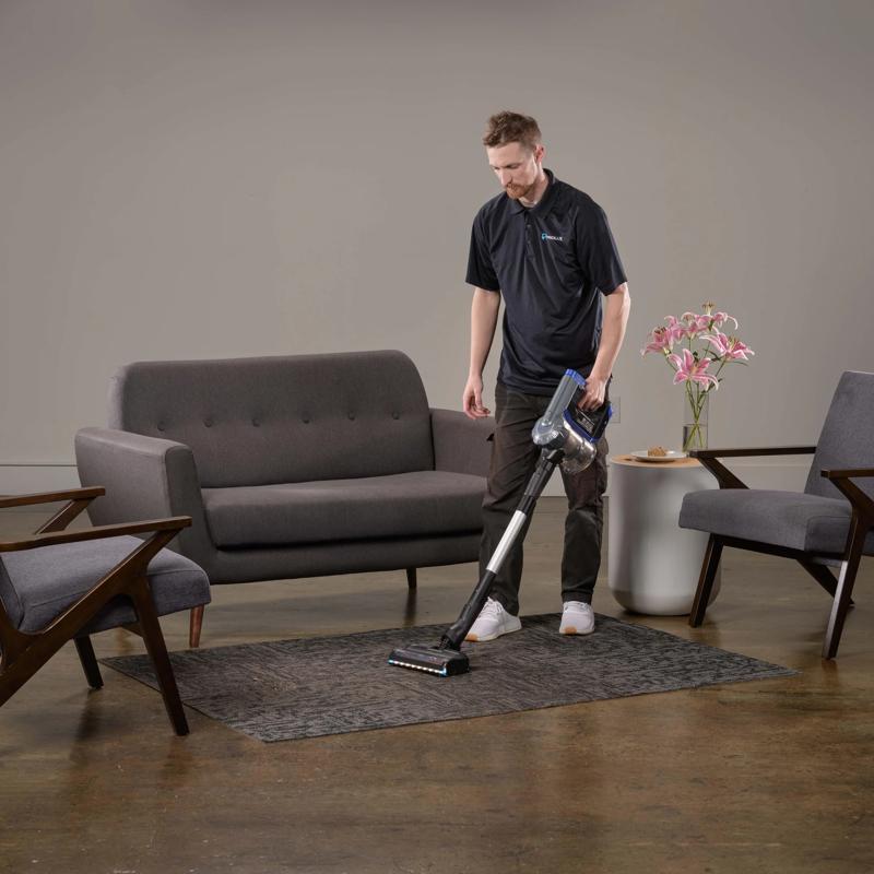 Prolux RS7 PET Cordless Handheld Stick Vacuum man using in living room.