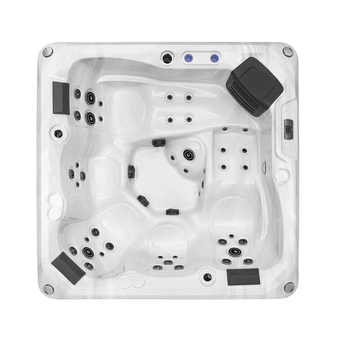 White hot tub with multiple jet nozzles, contoured seating areas, and a black control panel in the corner.