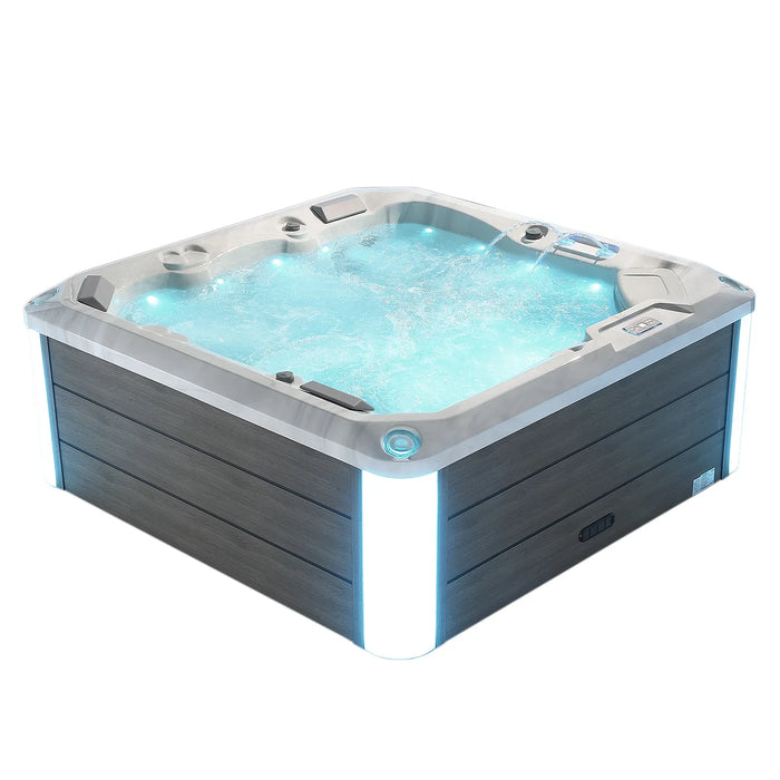 Aqua-colored hot tub with bubbling water and blue ambient lighting, featuring a gray wooden exterior and silver trim.