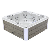 White and gray square hot tub with multiple water jets and wooden paneled exterior