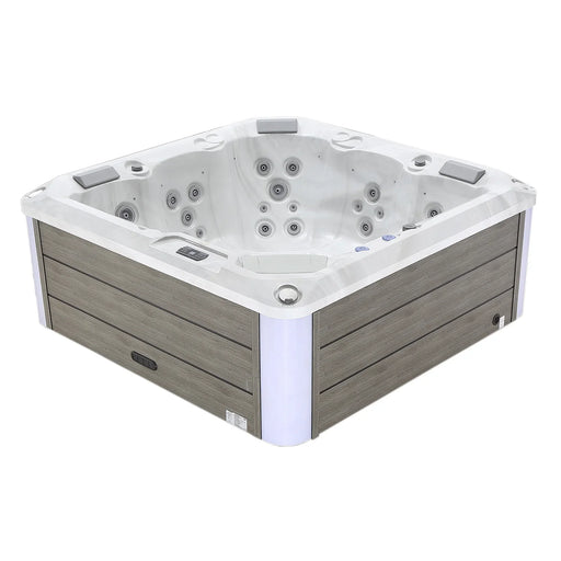 White and gray square hot tub with multiple water jets and wooden paneled exterior