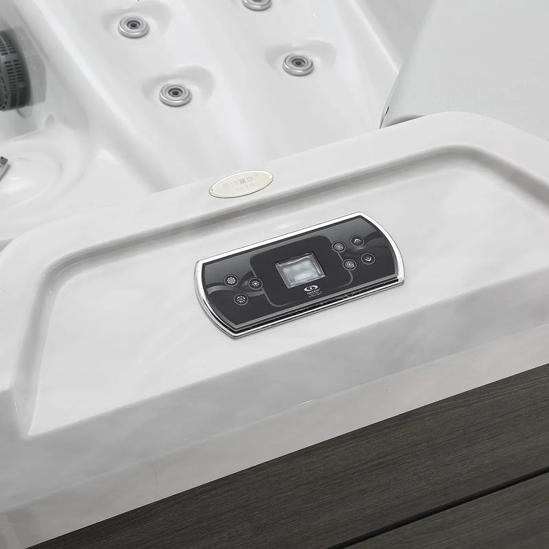 White hot tub with digital control panel, chrome-trimmed with circular jets and dark wooden border
