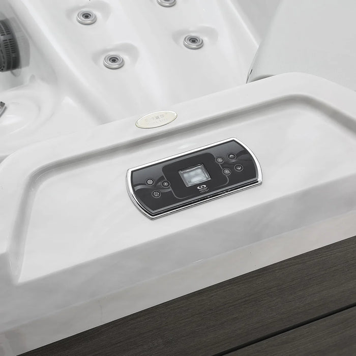 White hot tub with digital control panel, chrome-trimmed with circular jets and dark wooden border
