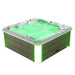Hot tub with glowing green water and green accent lighting, filled with bubbling water and white and green exterior panels.