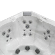 White hot tub interior with multiple gray circular jets positioned symmetrically across curved surface.