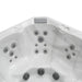 White hot tub interior with multiple gray circular jets positioned symmetrically across curved surface.