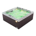 Hot tub with glowing green bubbling water and built-in lighting, showing square spa with dark base and white trim.