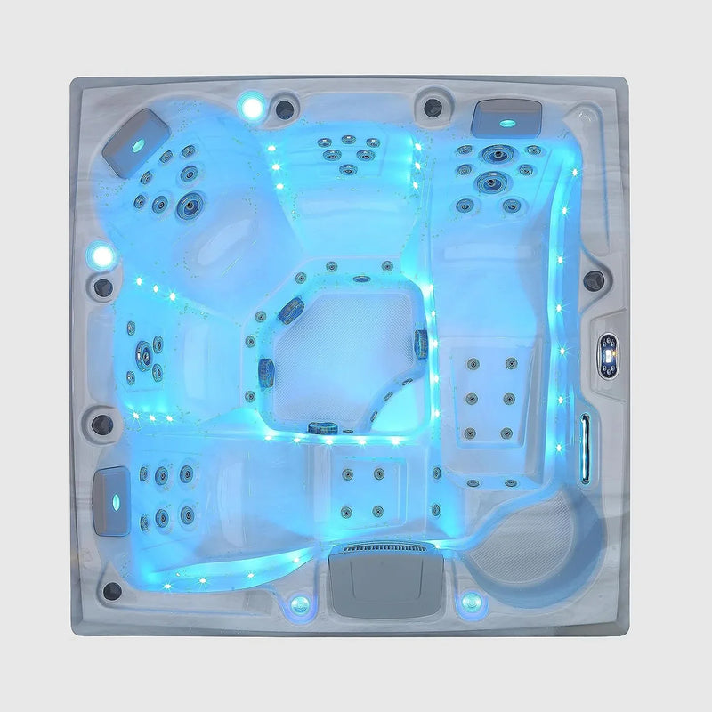 Overhead view of a blue-lit hot tub with multiple seating areas and illuminated jets, shown from a top-down perspective.