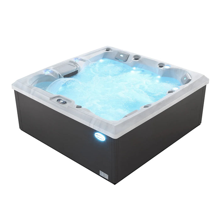 Hot tub with bubbling blue water, white trim, and dark gray base with illuminated control panels.