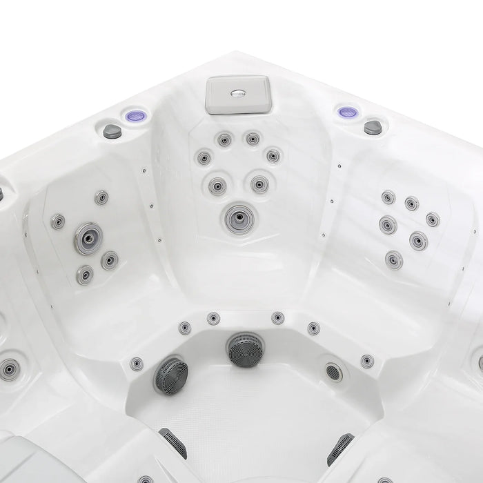 White hot tub interior with multiple gray jet nozzles arranged in curved clusters, showing contoured seating and control panel.