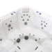 White hot tub interior with multiple gray jet nozzles arranged in curved clusters, showing contoured seating and control panel.