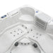 White hot tub with multiple jets, digital control panel, and curved seating design from overhead view.