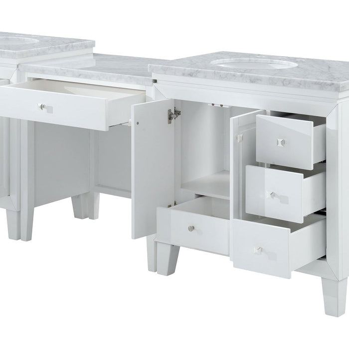 White bathroom vanity with marble top, open drawers, and cabinet door, showcasing storage compartments and clean, modern design.