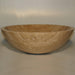 Wooden bowl with smooth, curved sides and rich, swirling grain pattern in warm beige tones