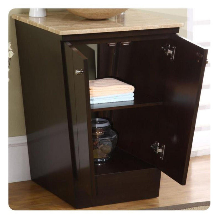 Dark wood bathroom storage cabinet with open doors, revealing folded towels and a glass jar on shelves, topped with light wood surface.