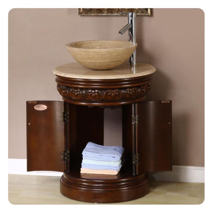 Ornate wooden bathroom vanity with marble vessel sink, carved base, and open cabinet storing folded towels