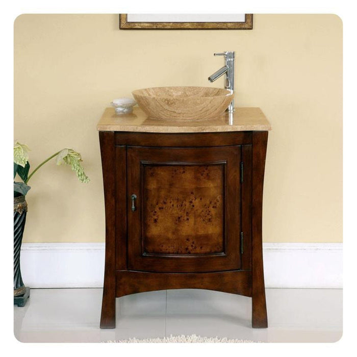 Dark wood bathroom vanity with travertine vessel sink and modern chrome faucet, against cream-colored wall