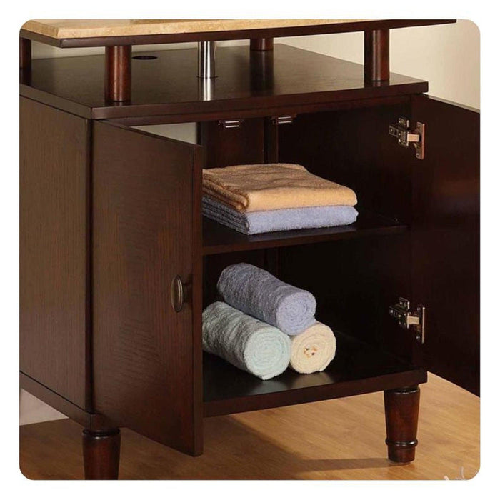 Dark wood bathroom vanity with open cabinet doors, neatly stacked tan and gray towels on shelves.