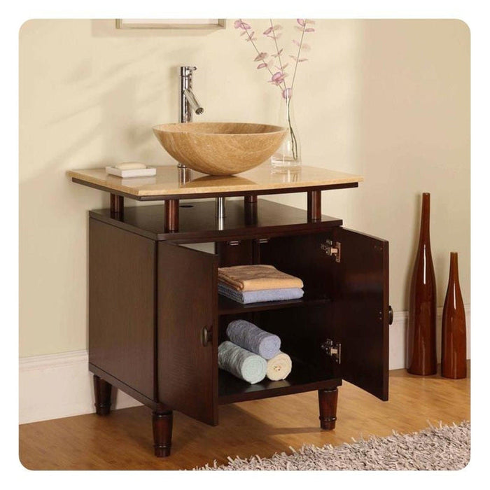 Dark wood bathroom vanity with stone vessel sink, open cabinet revealing rolled towels, and slender vases with pink branches.