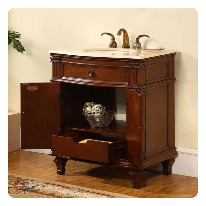 Elegant wooden bathroom vanity with marble top, curved faucets, and open cabinet revealing decorative sphere.