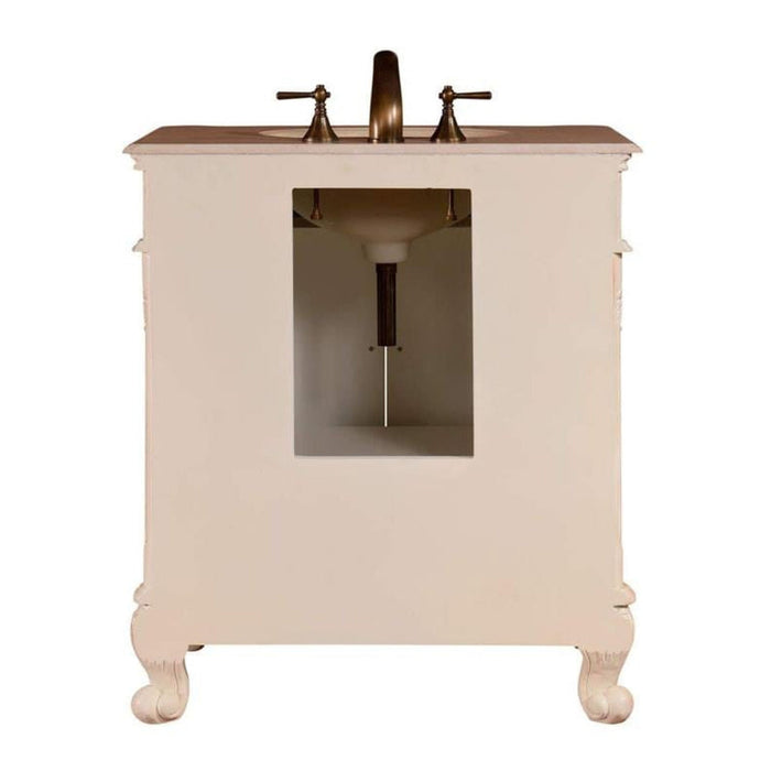 Vintage-style cream bathroom vanity with bronze faucet, curved cabriole legs, and open storage compartment.